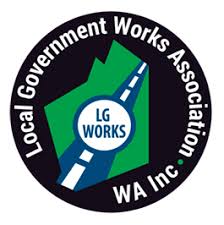 A circular logo with "Local Government Works Association WA Inc." written around the edge and "LG WORKS" in the center over a road graphic, symbolizing robust infrastructure and soil stabilisation.