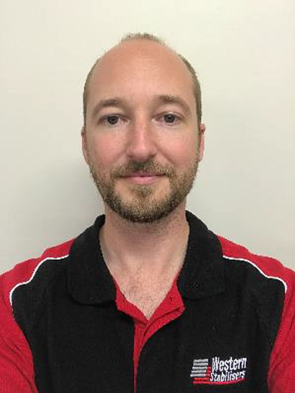 A man with a beard wearing a black and red polo shirt featuring a "Western Stabilizers" logo stands against a plain background.