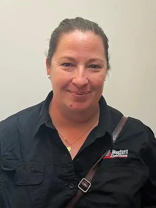 A woman with her hair tied back smiles at the camera, wearing a black shirt with "Western Starworks" embroidered on it.